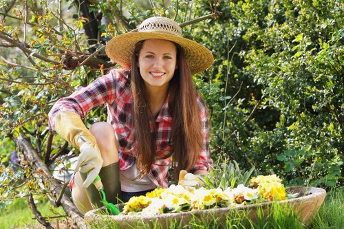 Professional garden maintenance tasks including lawn mowing and pruning